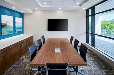 a conference room with a wooden table and chairs at Hampton Inn By Hilton Hamilton in Hamilton