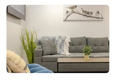 a living room with a couch and a table at LUXURIOUS 1000 SQ FT Oasis in Brampton