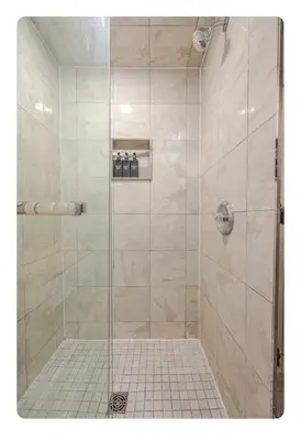 a bathroom with a shower with a glass door at LUXURIOUS 1000 SQ FT Oasis in Brampton