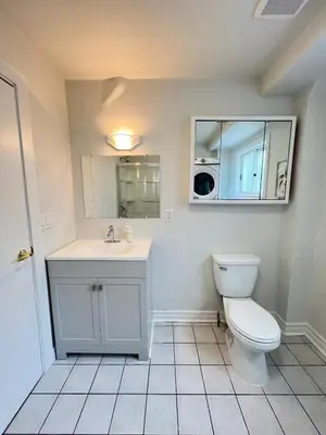 a bathroom with a toilet and a sink at Letitia Heights !A Spacious and Quiet Private Bedroom with Shared Bathroom in Barrie
