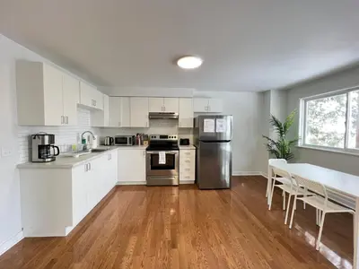 a kitchen with white cabinets and stainless steel appliances at Letitia Heights !B Spacious and Quiet Private Bedroom with Shared Bathroom in Barrie