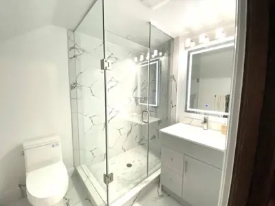 a bathroom with a shower and a toilet and a sink at Classic Home in Niagara Falls