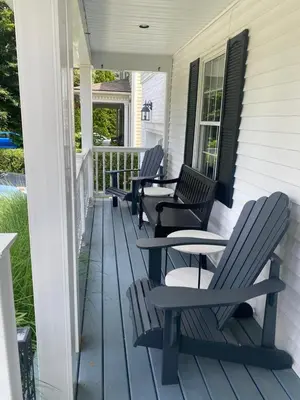a porch with chairs and tables on a house at Centre Gate House Licence# 117-2023 in Niagara on the Lake