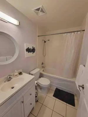 a bathroom with a sink and a toilet and a shower at City Centre Lodge ( Downtown) in Mississauga