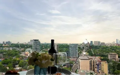 a bottle of wine and a glass with a city at Luxury 3-Beds Apartment in Yorkville with the Best City View in Downtown Toronto in Toronto