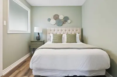a bedroom with a large bed and a window at 3BR Bright Mountain View Condo at Blue on Monterra in Blue Mountains