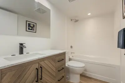 a bathroom with a sink and a toilet and a tub at Cozy 2BR Close to CN Tower & Harbourfront in Toronto