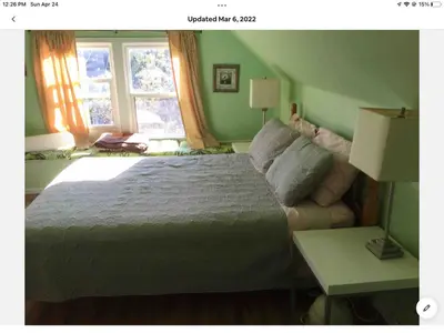a bedroom with a large bed and a window at Cozy 1-bedroom loft with falls view 4mins to falls in Niagara Falls