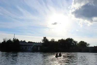 two people on a boat in the water at Balsam Lake Cottage 5 Bed room in Kawartha Lakes
