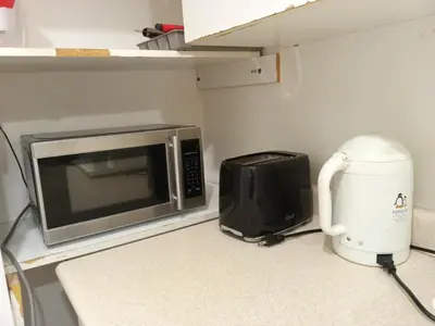 a microwave oven sitting on a counter next to a appliance at spacious and bright house in Toronto
