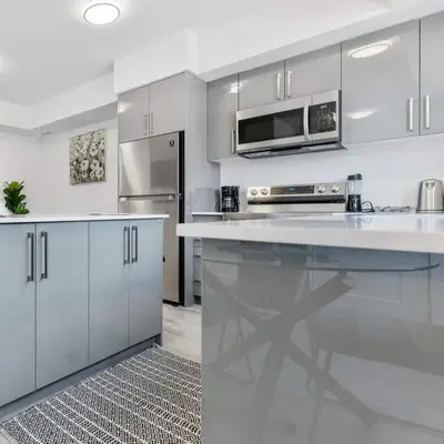 a kitchen with white cabinets and a white counter top at Entire Luxury Suite 4Mins To Falls, Free Parking in Niagara Falls