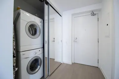 a laundry room with a washer and dryer at Cozy 1 BR Air mattress CN Tower Ent District MTCC in Toronto