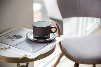 a coffee cup sitting on a table next to a chair at Cozy 1 BR Air mattress CN Tower Ent District MTCC in Toronto