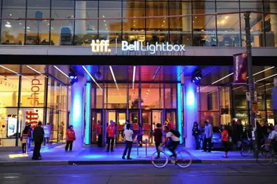 a group of people standing outside of a building at 1 BR Furnished Condo with Balcony across CN Tower in Toronto