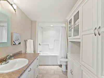 a white bathroom with a sink and a toilet at Getaway Cottage LAKE FRONT Muskoka Room Kayaks in Dwight
