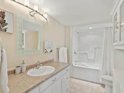 a white bathroom with a sink and a shower at Getaway Cottage LAKE FRONT Muskoka Room Kayaks in Dwight