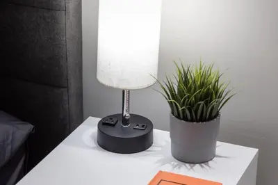 a lamp on a table next to a potted plant at Luxury CN Tower View King Bed Balcony FREE PARK in Toronto