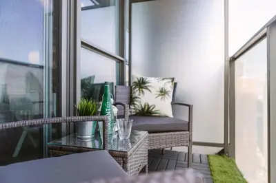 a balcony with a chair and a glass table at Skyline Waterfront 2BR plus 2BA wParking near MTCC in Toronto