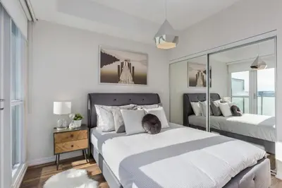 a bedroom with two beds and a mirror at Skyline Waterfront 2BR plus 2BA wParking near MTCC in Toronto