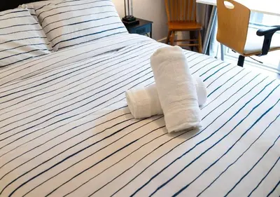 a bed with two rolled up towels on it at Welcoming Downtown Condo with WFH setup Balcony in Toronto