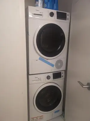 two washing machines stacked on top of each other at Downtown Toronto Condo Suite in Toronto