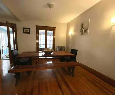 a dining room with a wooden table and chairs at Vintage cute house 5 min from the beautiful Falls! in Niagara Falls