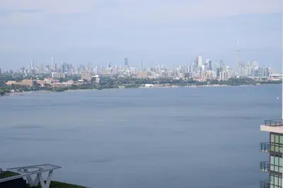 a large body of water with a city in the background at Modern luxury Waterfront Condo in Mississauga