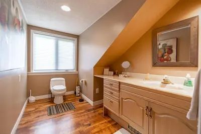 a bathroom with a sink and a toilet and a window at Waterfront - Kawartha Lakes in Kawartha Lakes