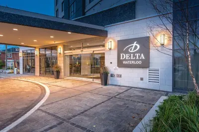a building with a sign on the side of it at Delta Hotels by Marriott Waterloo in Waterloo