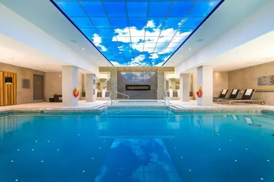 a pool in a hotel with a ceiling at Delta Hotels by Marriott Waterloo in Waterloo