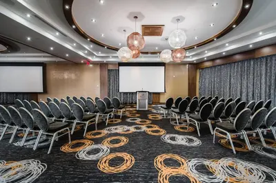 a conference room with chairs and a projection screen at Delta Hotels by Marriott Waterloo in Waterloo