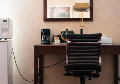 a chair sitting at a desk in a hotel room at Royal Inn and Suites at Guelph in Guelph
