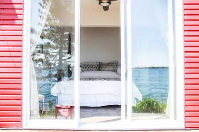 a window of a house with a bed in it at SkyTime Vacations in Wellington