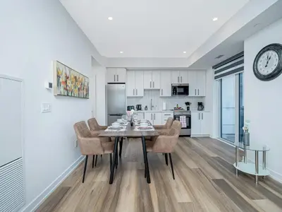 a kitchen and dining room with a table and chairs at City View 1BR Condo - King Bed & Private Balcony in Kitchener