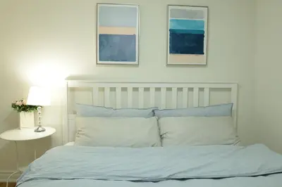a bedroom with a bed with blue and white pillows at Spacious 2-Bed-Room near Yonge & Major Mackenzie in Richmond Hill