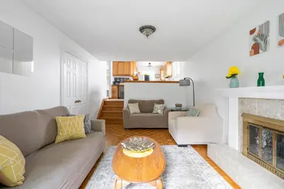 a living room with a couch and a table at Glengarry Haus Spacious 2BR Home Away From Home in Mississauga