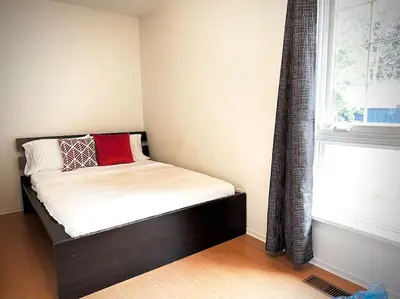 a small bed in a room with a window at Cottage Retreat on 11 Acres in Flesherton