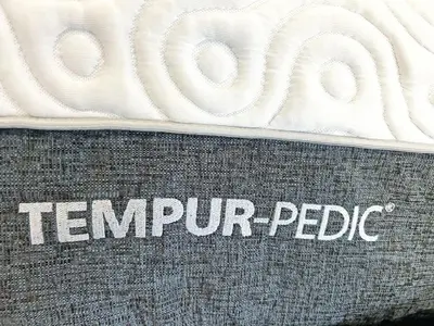 a close up of the word tempur pedic on a mattress at Luxe Home Near Limeridge - Sleeps 11 - Pool in Hamilton