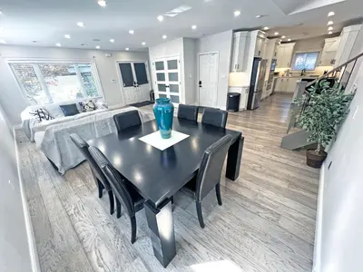 a black dining room table with black chairs and a couch at Luxe Home Near Limeridge - Sleeps 11 - Pool in Hamilton