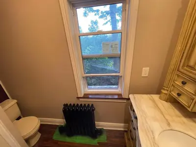a bathroom with a toilet and a window at THE RED STAR room E in Niagara Falls
