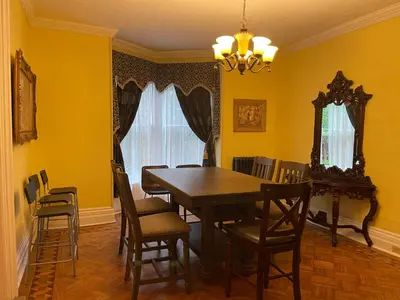 a dining room with a wooden table and chairs at THE RED STAR ROOM B in Niagara Falls