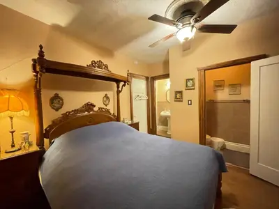 a bedroom with a bed and a ceiling fan at THE RED STAR ROOM B in Niagara Falls