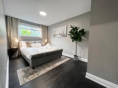 a bedroom with a bed and a potted plant at *NEW* Elegant Urban 2BR Retreat in London