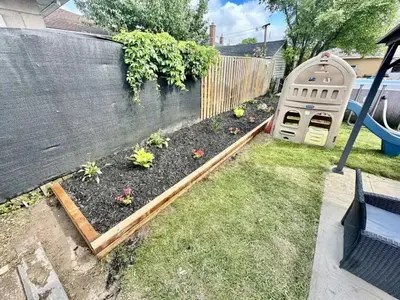 a garden with a dog house next to a fence at Hamilton Haven - Smart Tech and BBQ Oasis - Pool in Hamilton