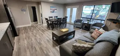 a living room with a couch and a table at Moira Lake Cottages in Madoc
