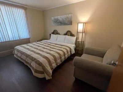a hotel room with a bed and a couch at Mariner motor hotel in Collingwood