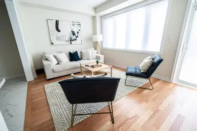 a living room with a couch and a chair at BRAND NEW home minutes from Niagara Falls. in Thorold