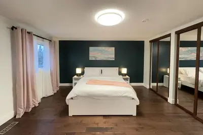 a bedroom with a large white bed and two lamps at Stylish Home in Prime Location North of Toronto in Richmond Hill