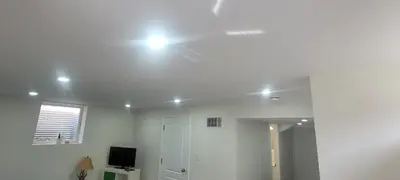 a white room with a light on the ceiling at Comfy basement near KW airport in Kitchener