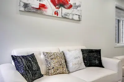 a white couch with pillows on it in a living room at 922 Logan Drive in Milton
